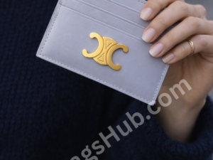 pastel-mauve-leather-card-holder-wallet-with-gold-logo-held-in-female-hand