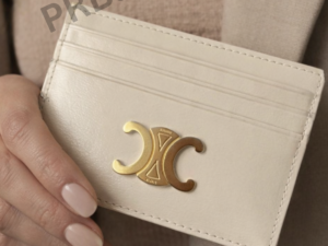 cream-leather-card-holder-in-female-hand-with-gold-logo-minimal-design