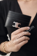 black-leather-card-holder-wallet-with-silver-logo-held-in-female-hand