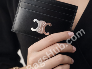 black-leather-card-holder-wallet-with-silver-logo-held-in-female-hand