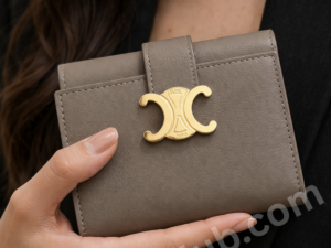 taupe-leather-wallet-with-gold-logo-clasp-held-in-woman-hand-premium-inspired-compact-wallet