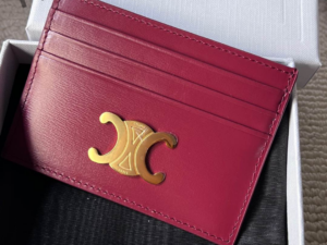deep-burgundy-card-holder-with-gold-logo-placed-in-luxury-box