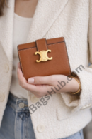brown-leather-wallet-with-gold-logo-compact-premium-inspired-dupe-held-in-hand
