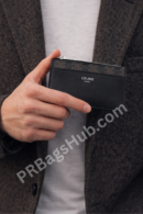 black-premium-inspired-card-holder-wallet-in-male-hand-compact-slim-design-with-zip-pocket-celine-style
