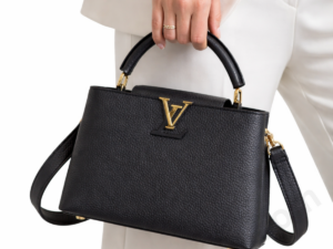 louis-vuitton-capucines-bb-m24655-black-leather-top-handle-bag-held-by-woman-with-shoulder-strap