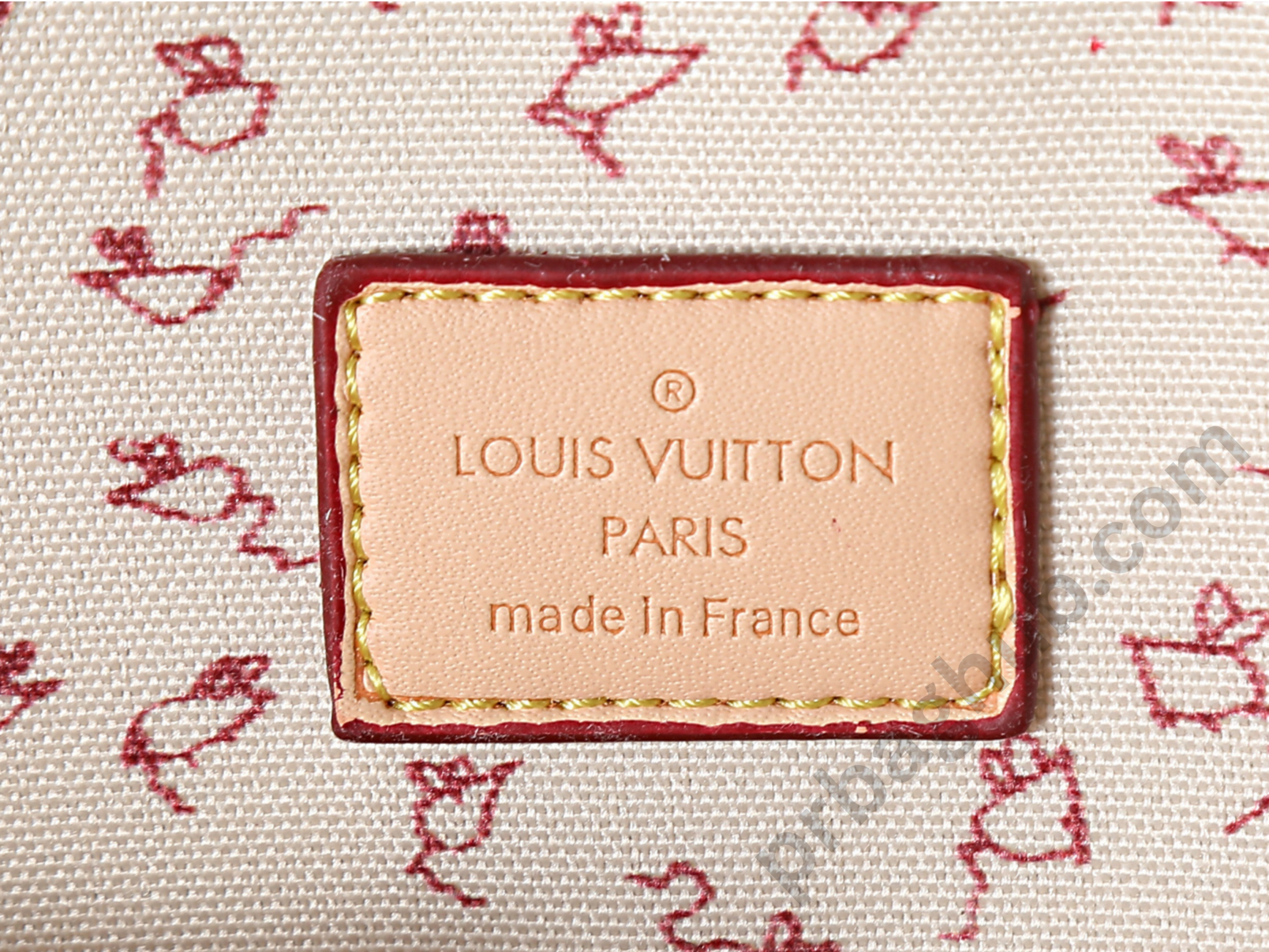 louis-vuitton-alma-mm-m27327-logo-tag-close-up-made-in-france-leather-label