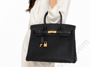 woman-holding-luxury-black-leather-handbag-with-gold-hardware-premium-designer-style-tote-on-white-background