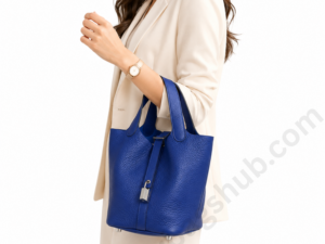 blue-bucket-handbag-in-woman-hand-white-background-luxury-style.png