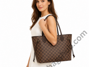 woman-holding-brown-checkered-tote-bag-on-white-background-designer-inspired-shoulder-handbag-with-gold-hardware-and-minimalist-fashion-style