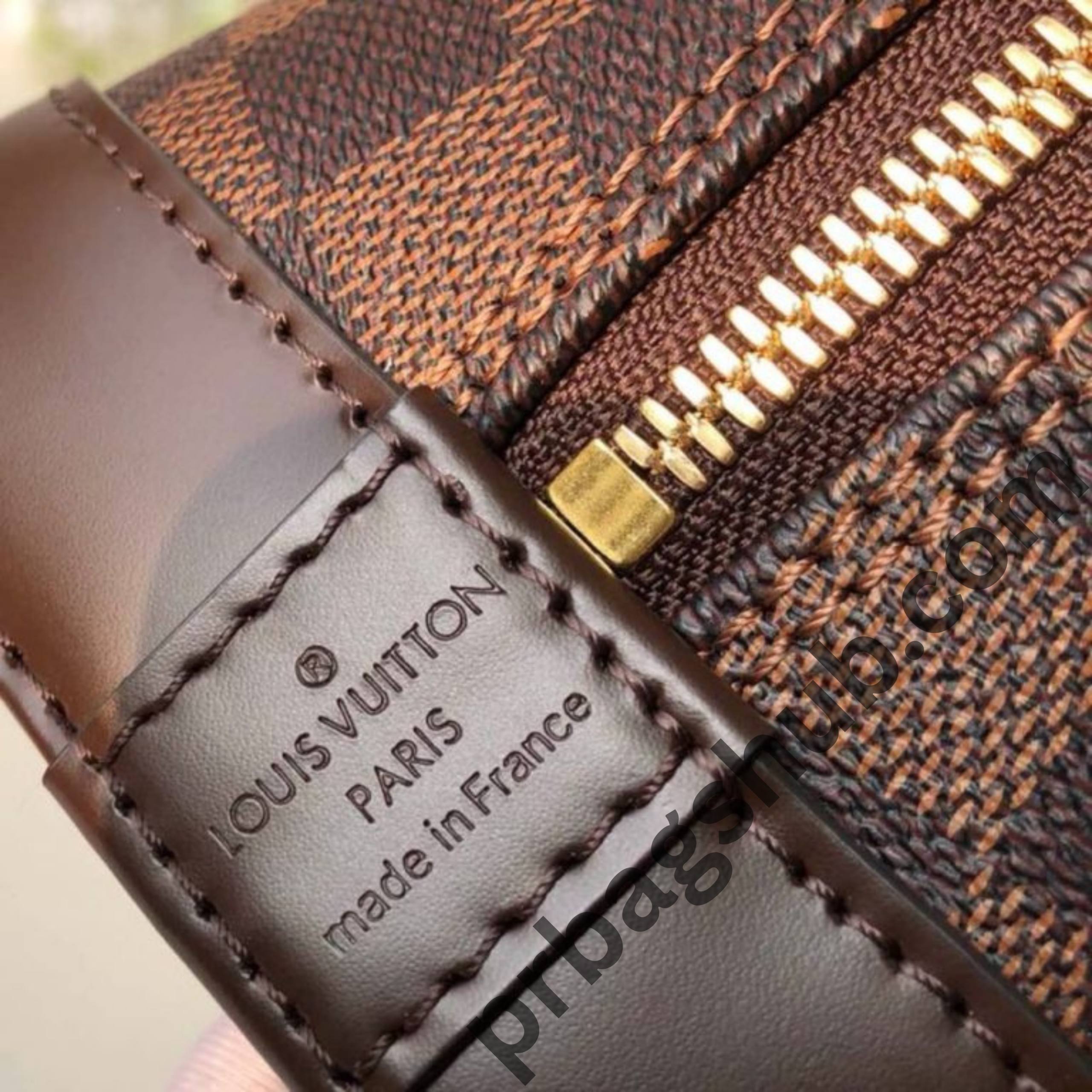close-up-of-louis-vuitton-alma-bb-inspired-handbag-zipper-and-brown-leather-trim-with-gold-hardware-detail