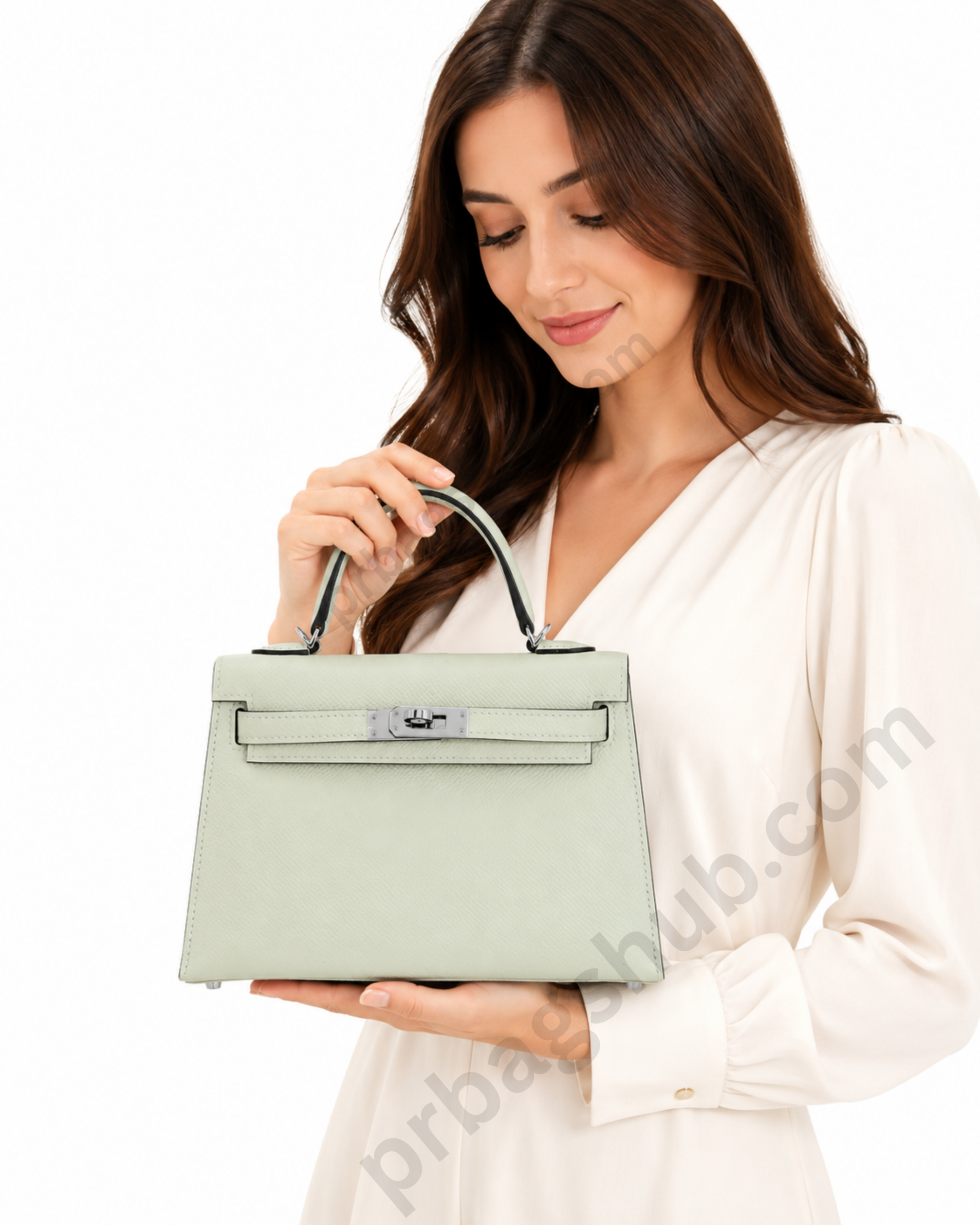 mint-green-kelly-style-top-handle-handbag-held-by-woman-in-white-dress-on-white-background