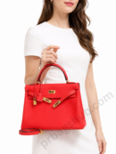 red-kelly-style-top-handle-handbag-held-by-woman-in-white-dress-with-gold-hardware-white-background